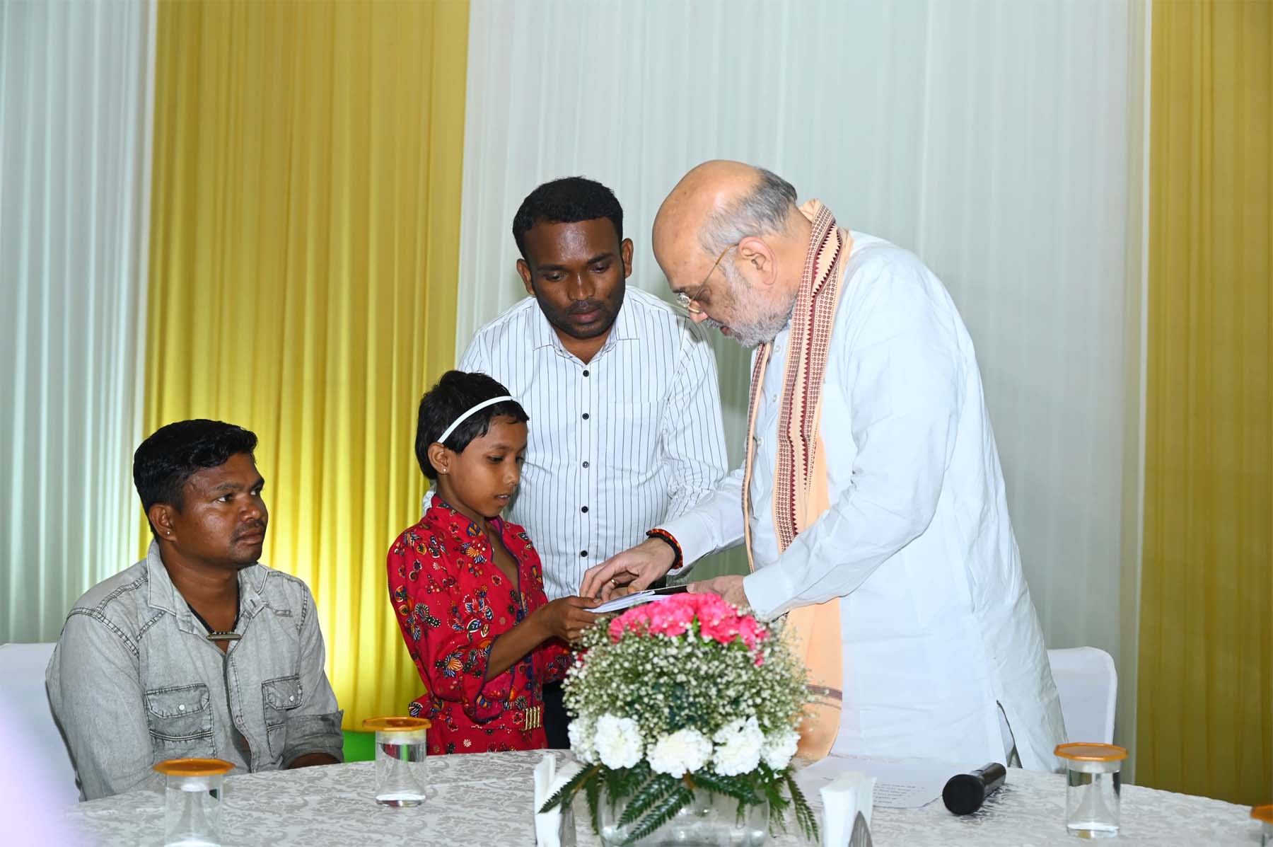 नक्सल प्रभावित परिजनाें के साथ आई बच्ची काे गृह मंत्री शाह उपहार भेंट करते हुए नक्सल प्रभावित परिजनाें के साथ आई बच्ची काे गृह मंत्री शाह उपहार भेंट करते हुए