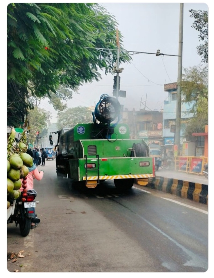 मशीन से छिड़काव करते कर्मी मशीन से छिड़काव करते कर्मी