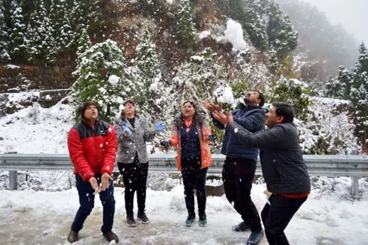 हिमालय दर्शन के पास बर्फ में खेलते-आनंद लेते सैलानी।