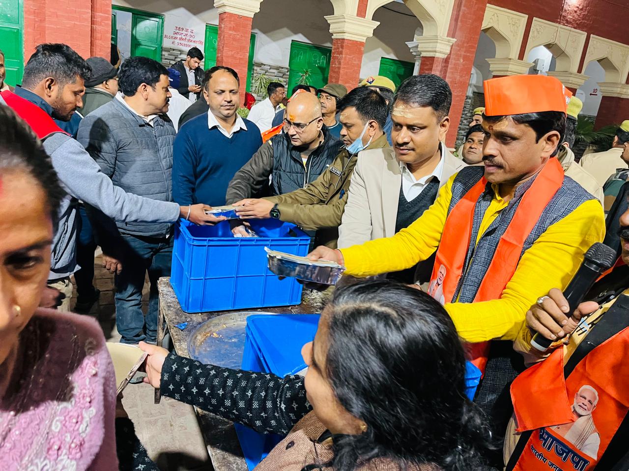 District Magistrate distributing food packets among the devotees District Magistrate distributing food packets among the devotees