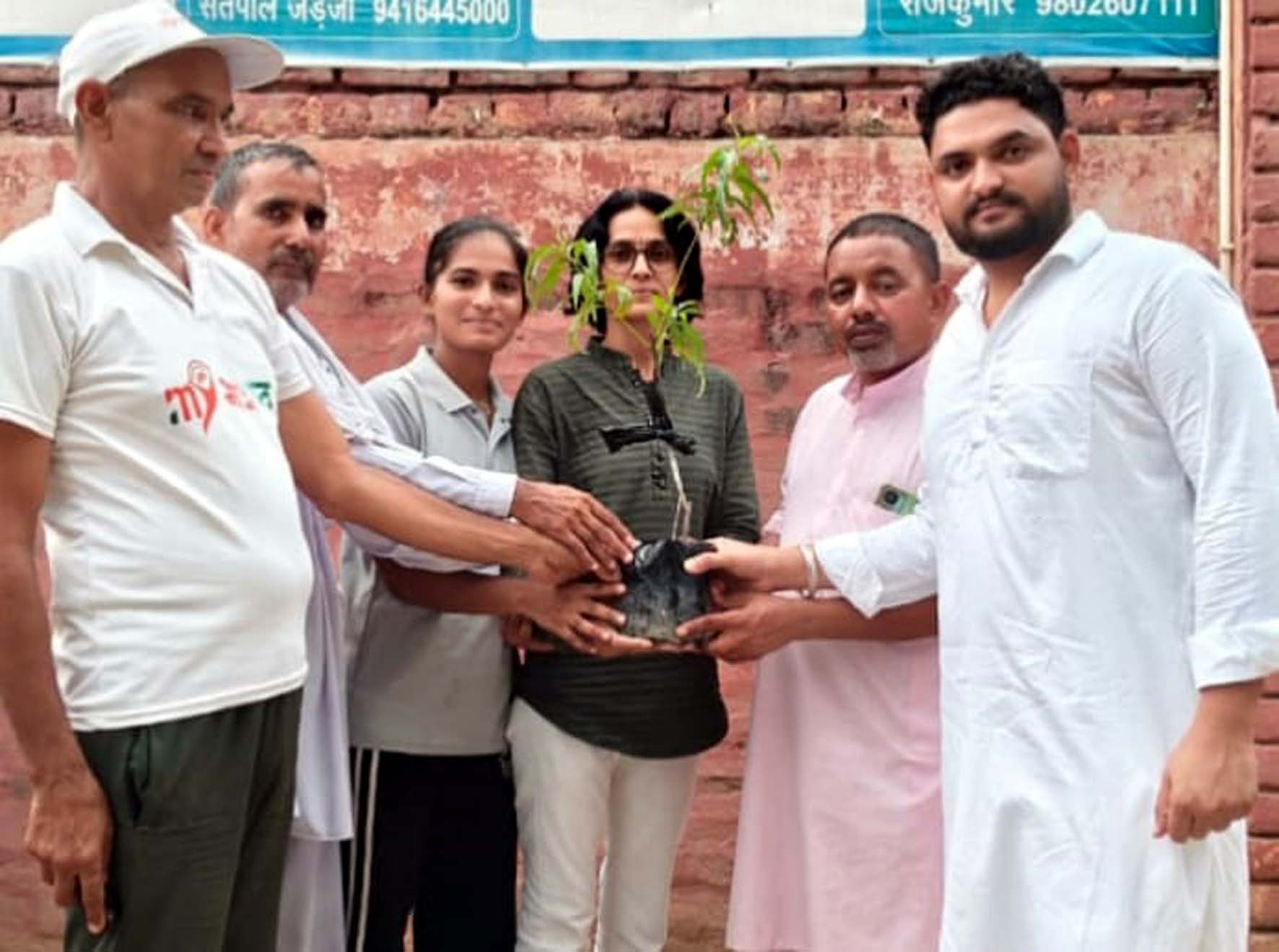 ग्रामीणों को पौधे वितरित करते पंच कविता। ग्रामीणों को पौधे वितरित करते पंच कविता।