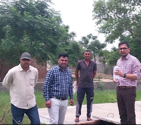 पानी की जांच करते हुए कर्मी।