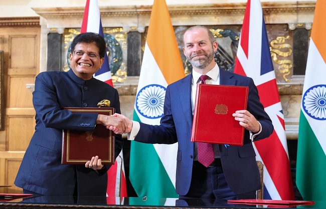 एफटीए पर हस्‍ताक्षर करते पीयूष गोयल और उनके ब्रिटिश समकक्ष जोनाथन रेनॉल्ड्स