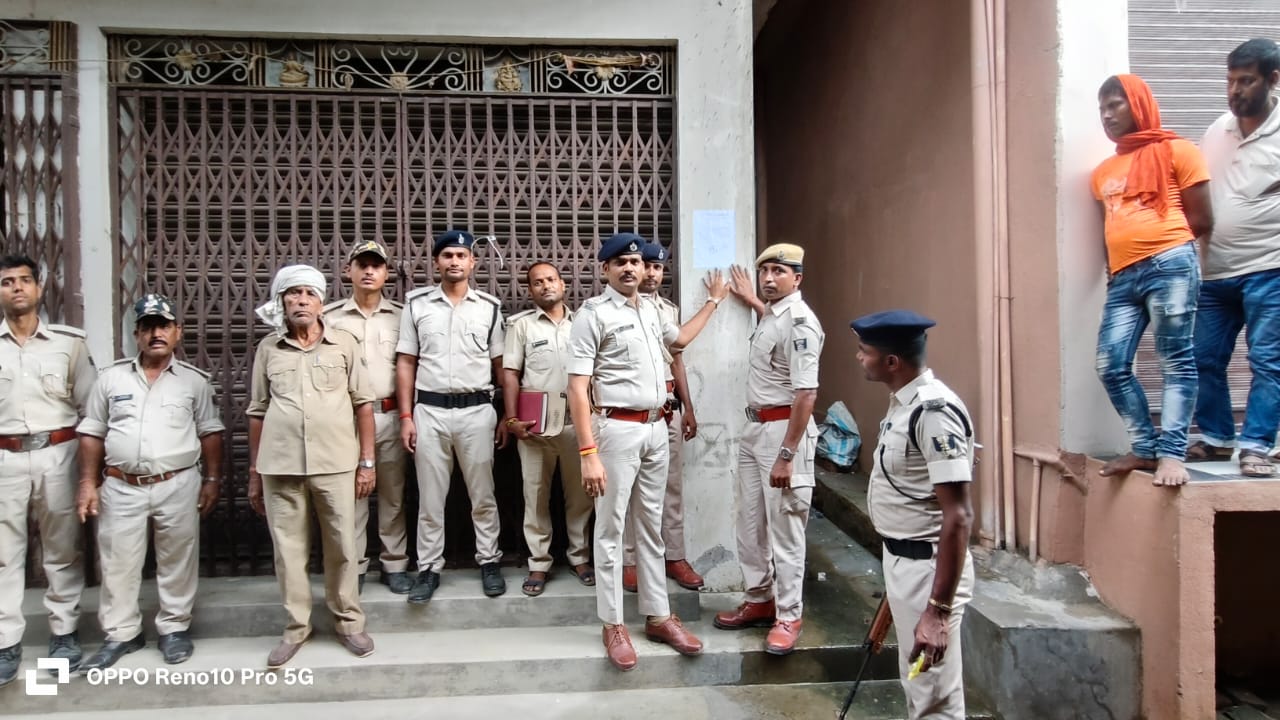 इश्तेहार चिपकाते पुलिस के अधिकारी