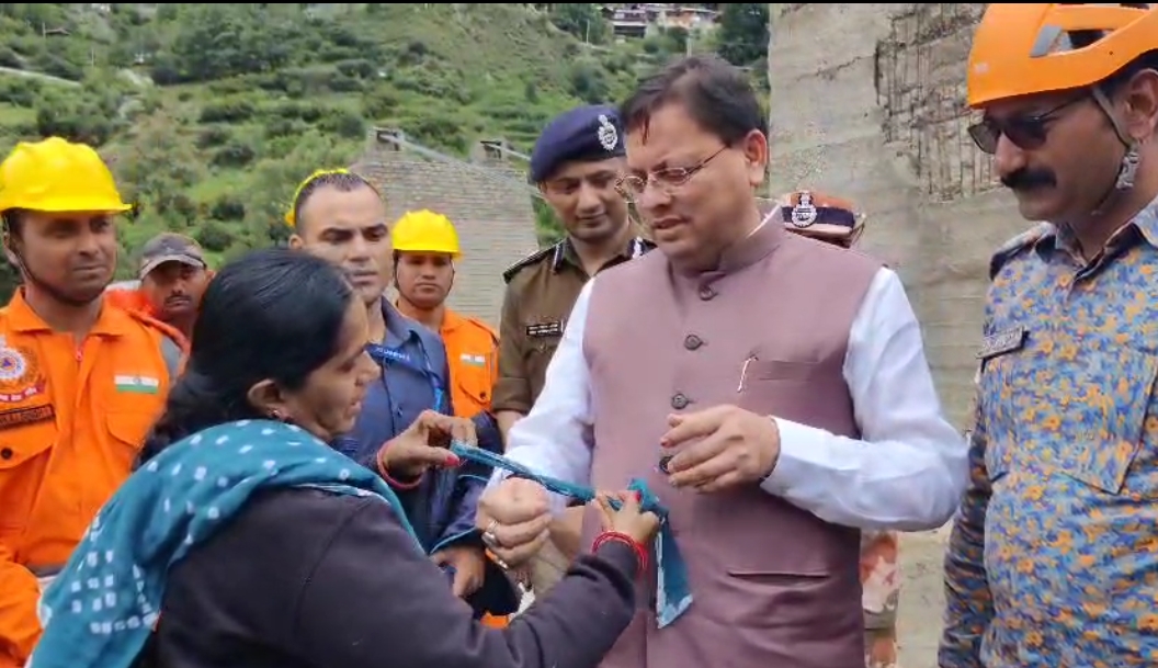 अहमदाबाद के ईशनपुर की रहने वाली धन गौरी बरोलिया धराली आपदा क्षेत्र में मुख्यमंत्री धामी को राखी बांधती।