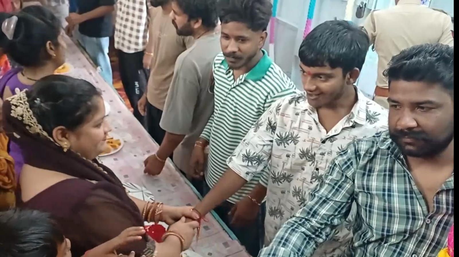 जिला जेल में बंद अपने भाइयों को राखी बांधती बहनें।