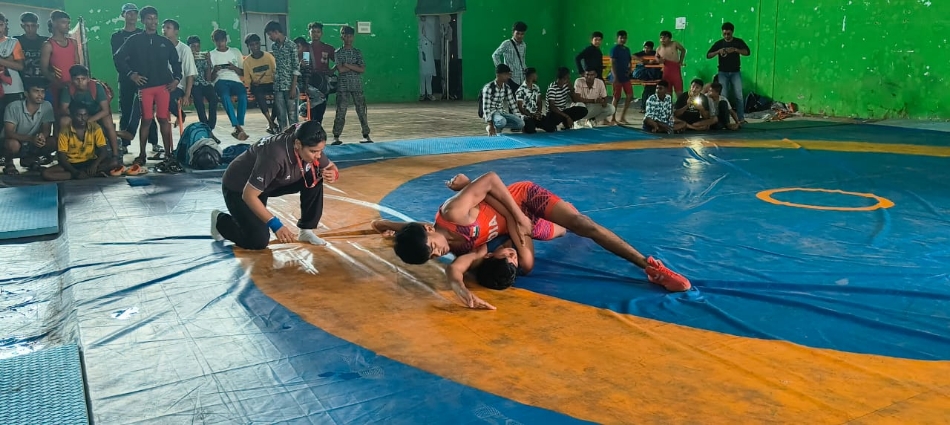 इंडोर स्टेडियम में आयोजित जिला स्तरीय कुश्ती चयन स्पर्धा में प्रदर्शन करते हुए बालक खिलाड़ी।