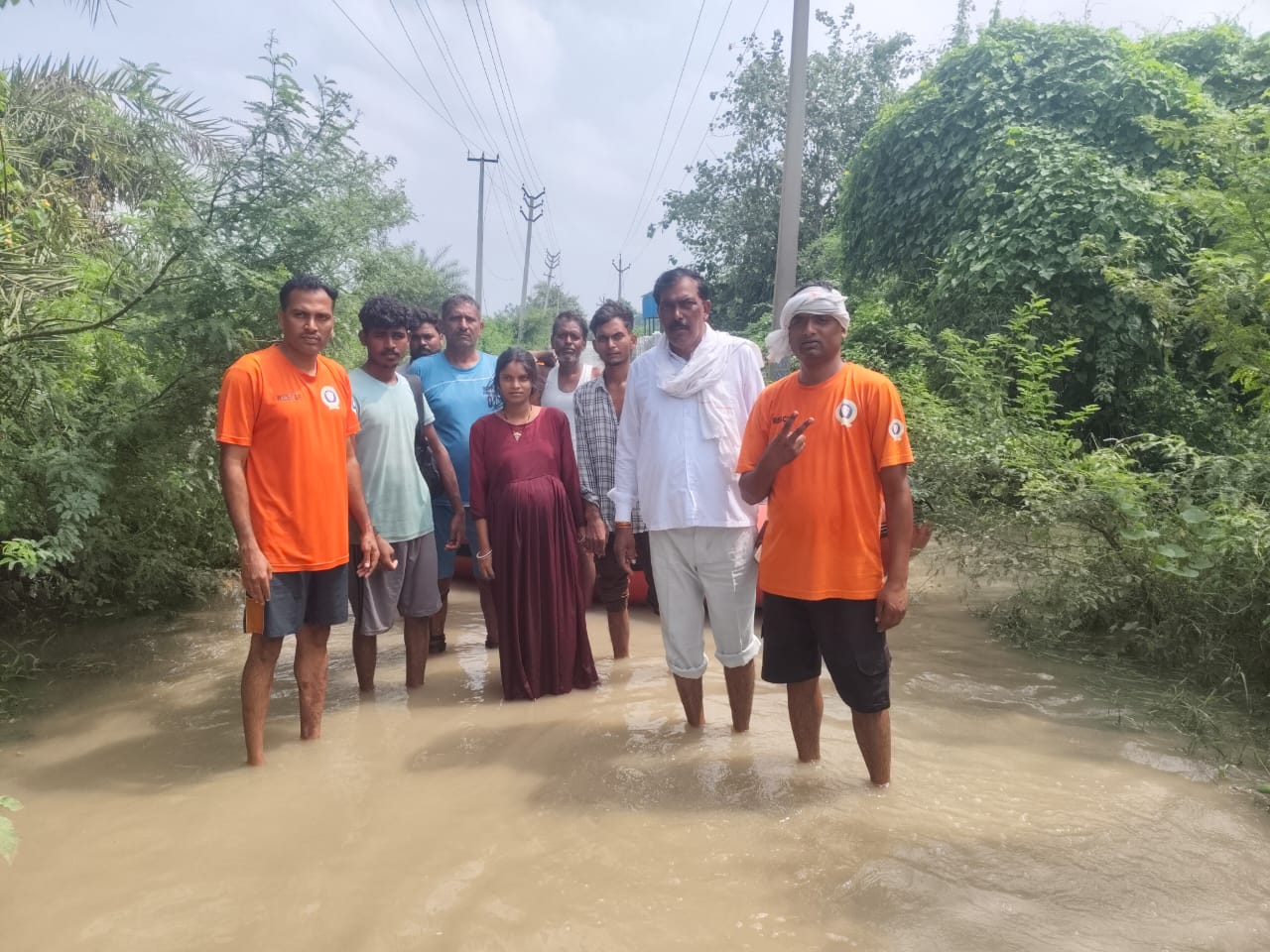 गर्भवती महिला का रेस्क्यू कर उसे सुरक्षित स्थान पर ले जाते प्रशासनिक कर्मचारी गर्भवती महिला का रेस्क्यू कर उसे सुरक्षित स्थान पर ले जाते प्रशासनिक कर्मचारी
