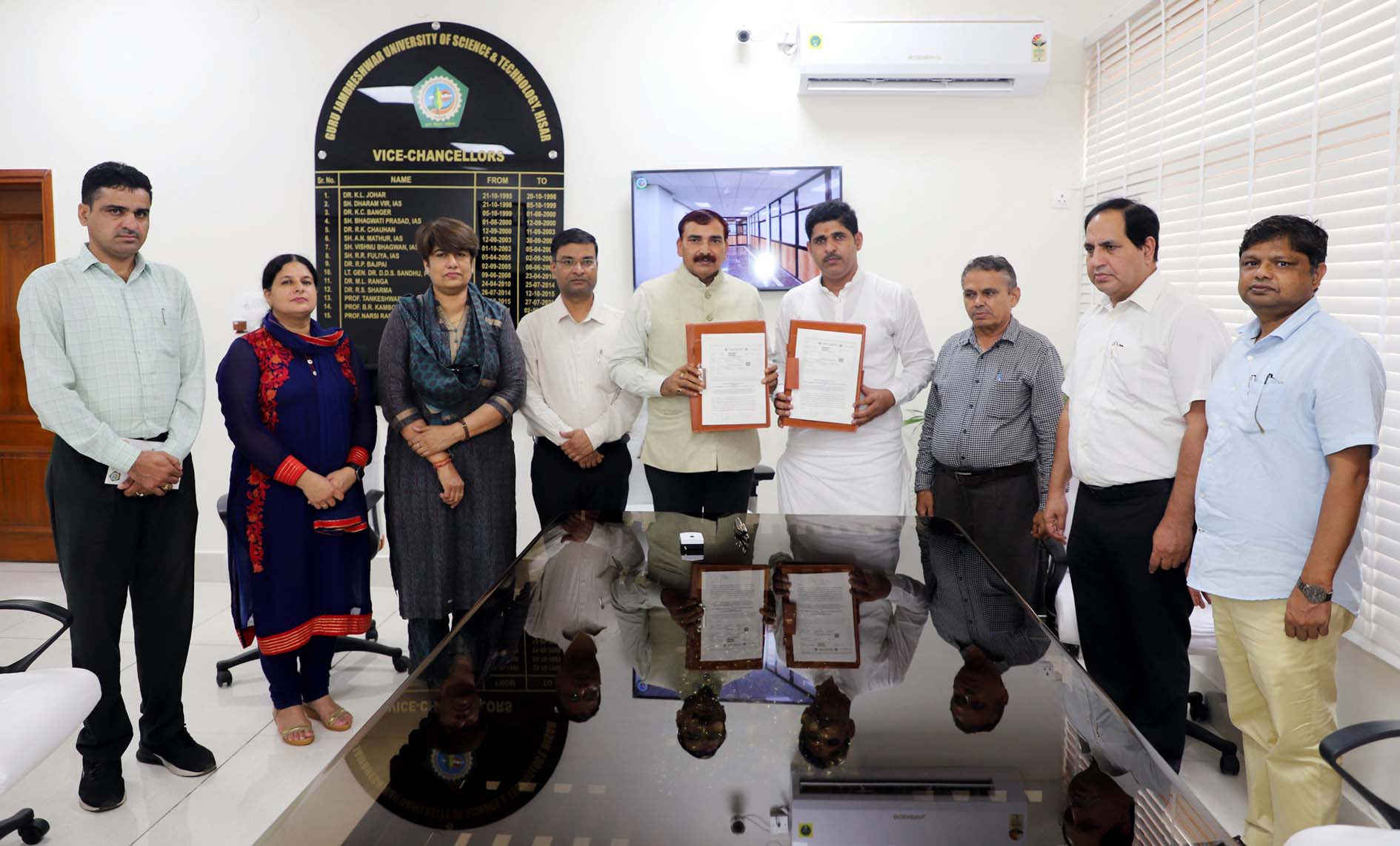कुलपति प्रो. नरसी राम बिश्नोई तथा जियो गीता के अध्यक्ष डा. तरूण एमओयू का आदान-प्रदान करते हुए।