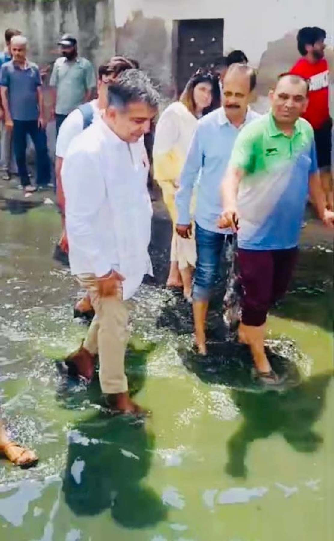 गुरुग्राम के विष्णु गार्डन में कई माह से गली में भरे गंदे पानी के बीच चलकर विरोध जताते कांग्रेस के जिला अध्यक्ष (शहरी) पंकज डावर व अन्य।