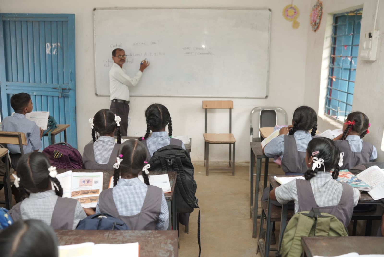 विज्ञान शिक्षक बच्चों को पढ़ाते हुए