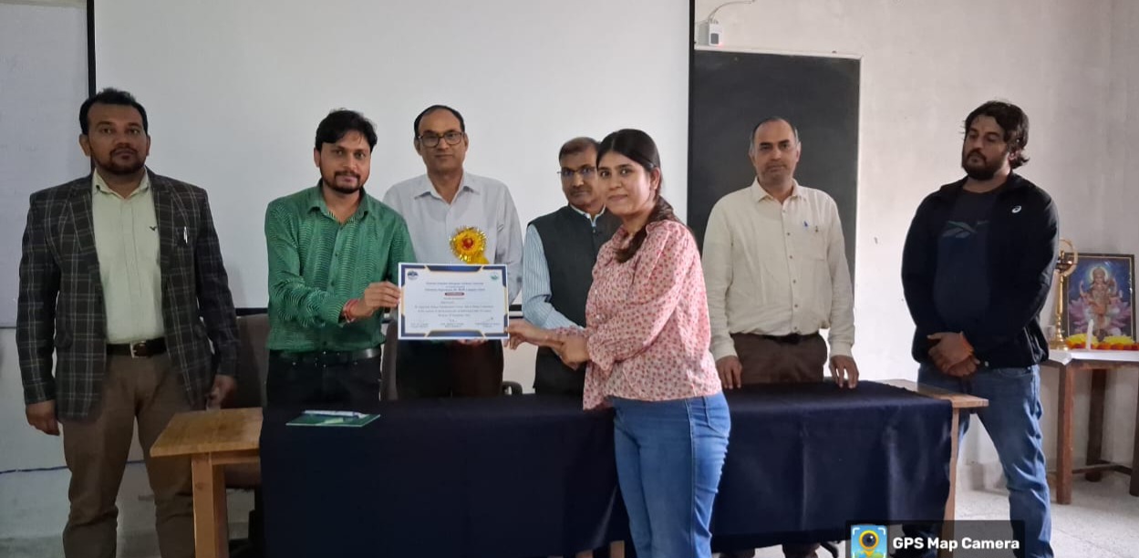पौड़ी परिसर में ओजोन दिवस पर प्रतियोगिता में अव्वल आने पर छात्रा को सम्मानित करते शिक्षक