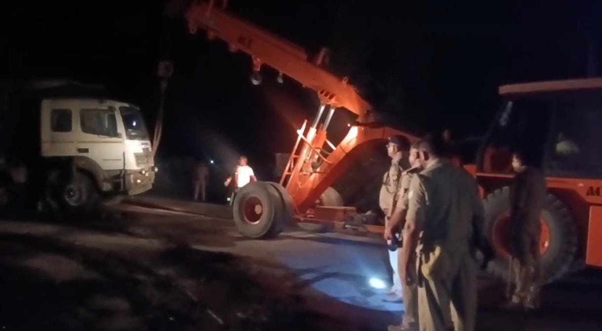 क्रेन की मदद से ट्रक हटवाती पुलिस