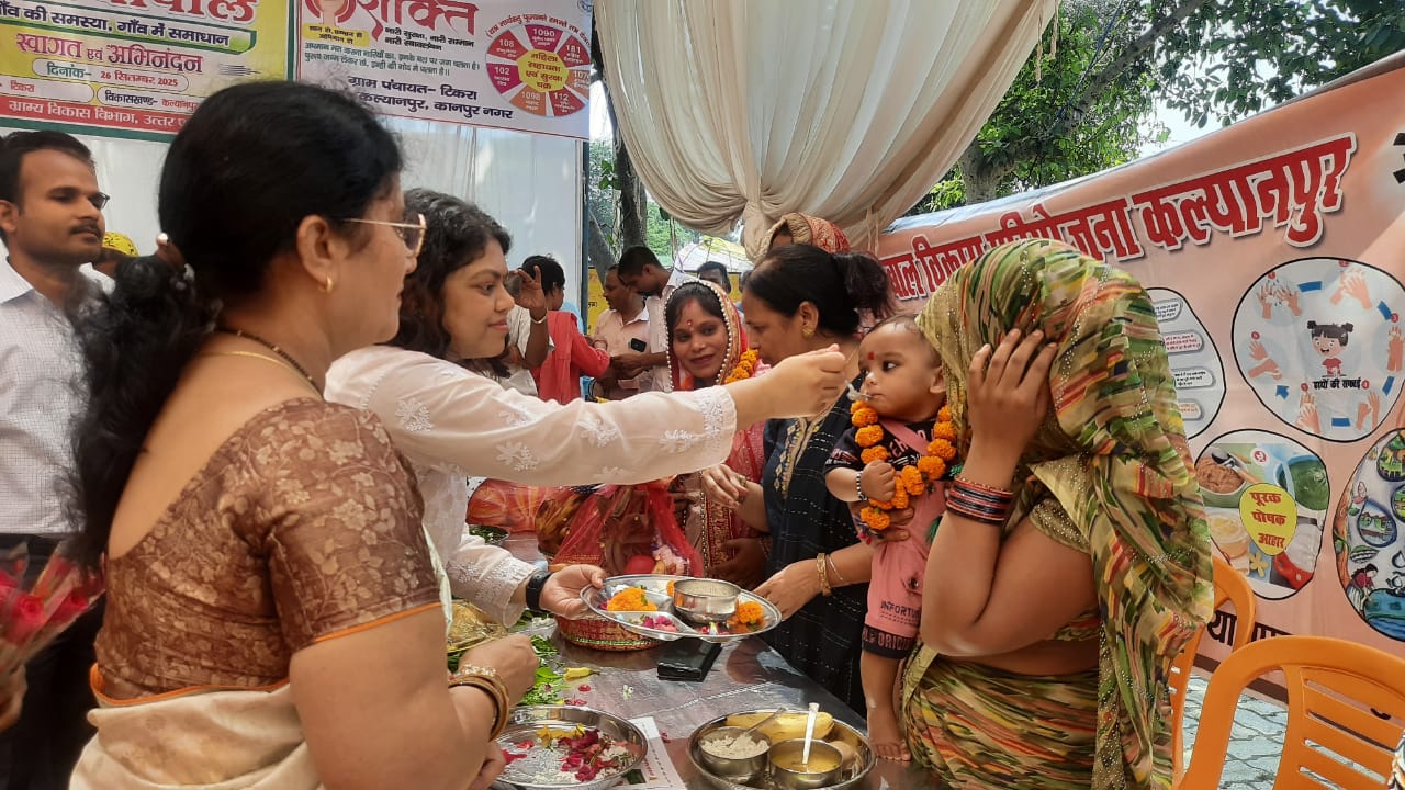 बच्चों को अन्नप्राशन संस्कार  कराती सीडीओ दीक्षा जैन व अन्य का छायाचित्र
