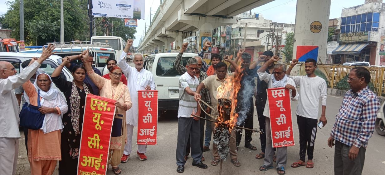 बहादुरगढ़ में डोनाल्ड ट्रंप का पुतला जलाते एसयूसीआई कार्यकर्ता।