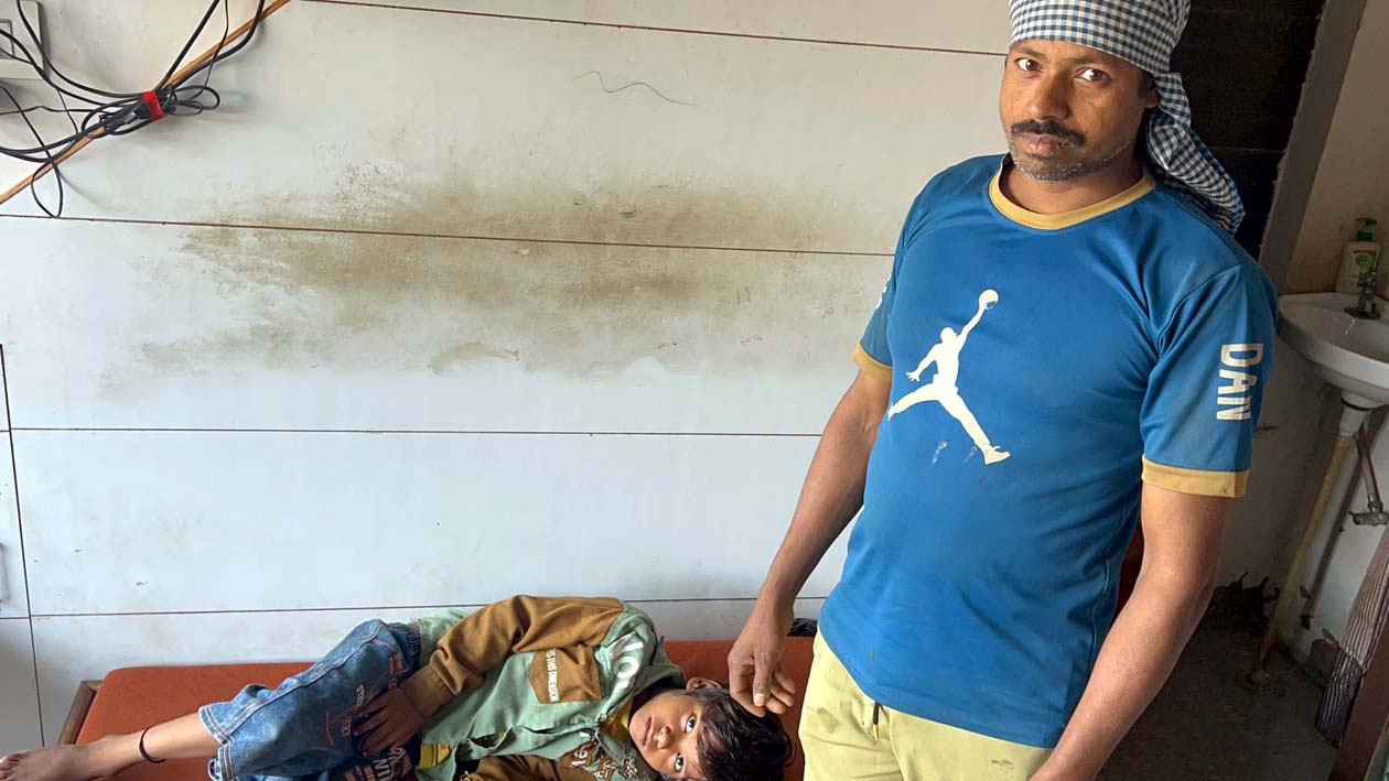 निजी अस्पताल में भर्ती घायल बच्चा राजन, उसके पास है उसके पिता भुवनेश्वर।