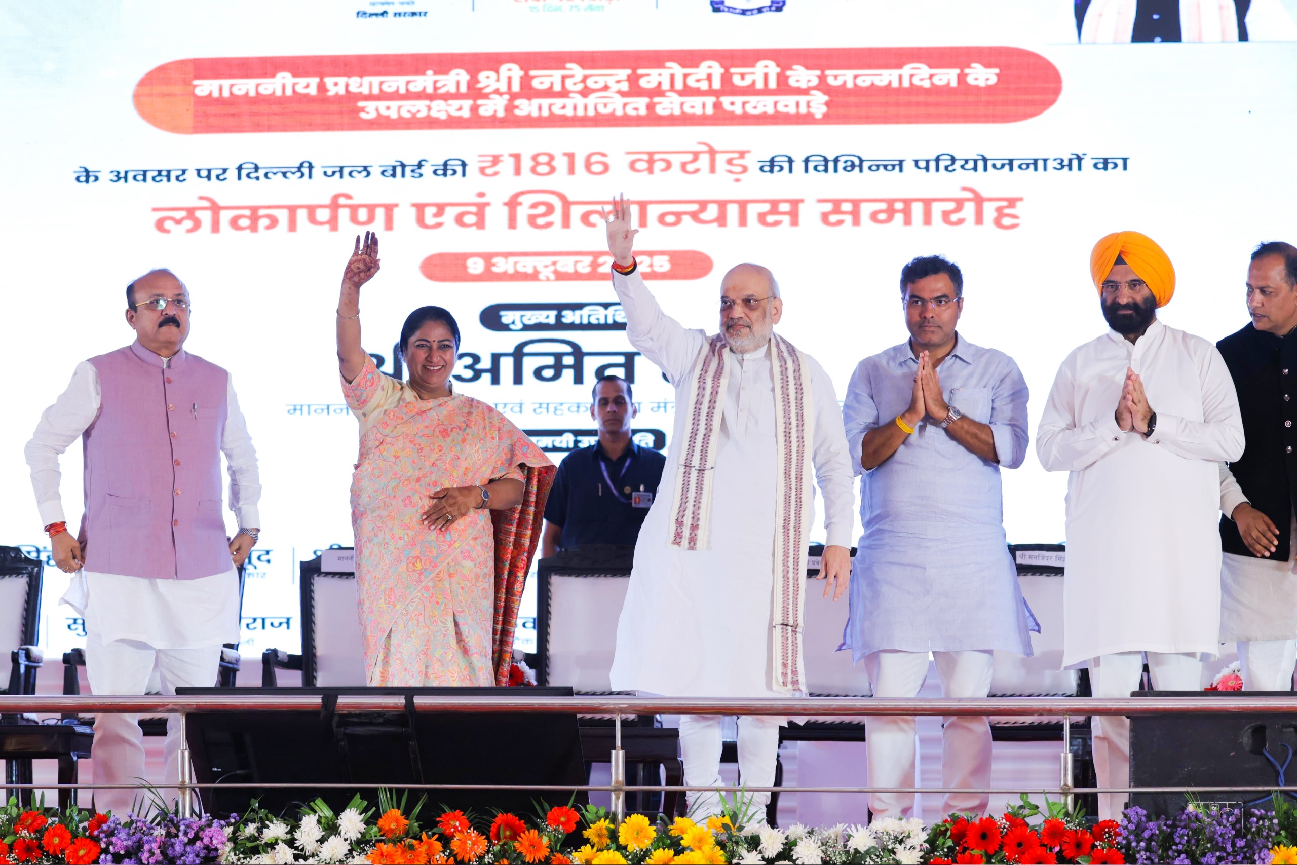 केशोपुर सीवेज ट्रीटमेंट प्लांट परिसर में गुरुवार को आयोजित समारोह में केंद्रीय गृह मंत्री अमित शाह के साथ जनता का अभिवादन करतीं दिल्ली की मुख्यमंत्री रेखा गुप्ता