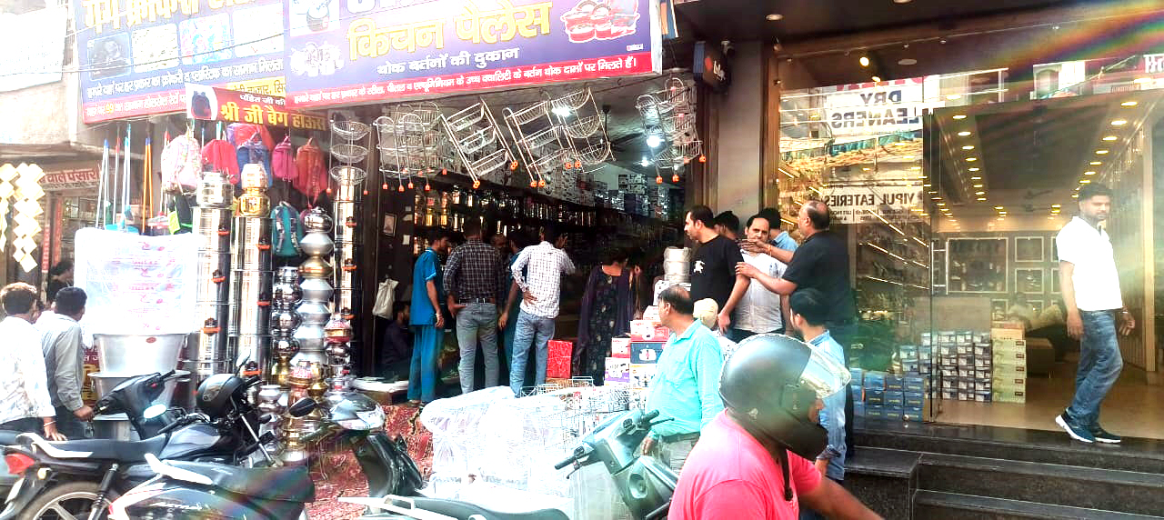 दुकान में बर्तनों की खरीददारी करते ग्राहक। दुकान में बर्तनों की खरीददारी करते ग्राहक।