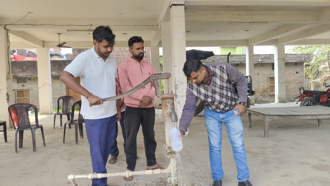 Departmental officer taking water sample