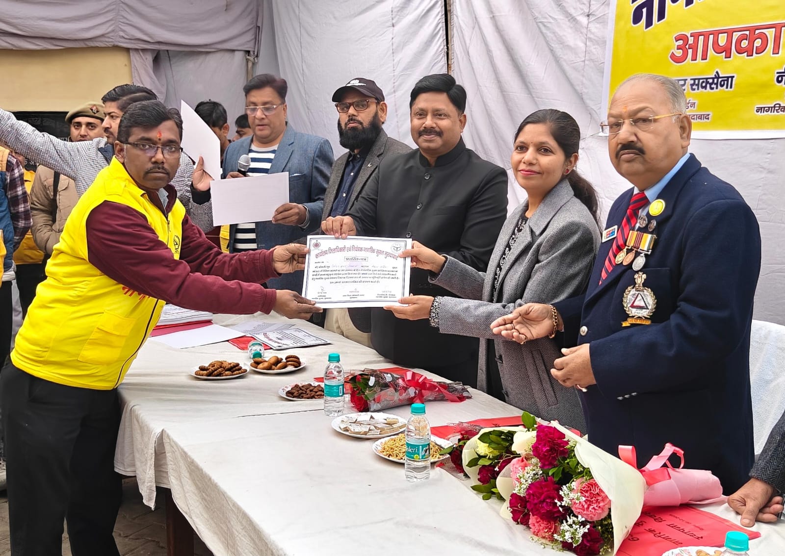 नागरिक सुरक्षा स्थापना दिवस पर सेक्टर वार्डेन निमित जायसवाल को प्रमाण पत्र देते जिलाधिकारी अनुज सिंह.