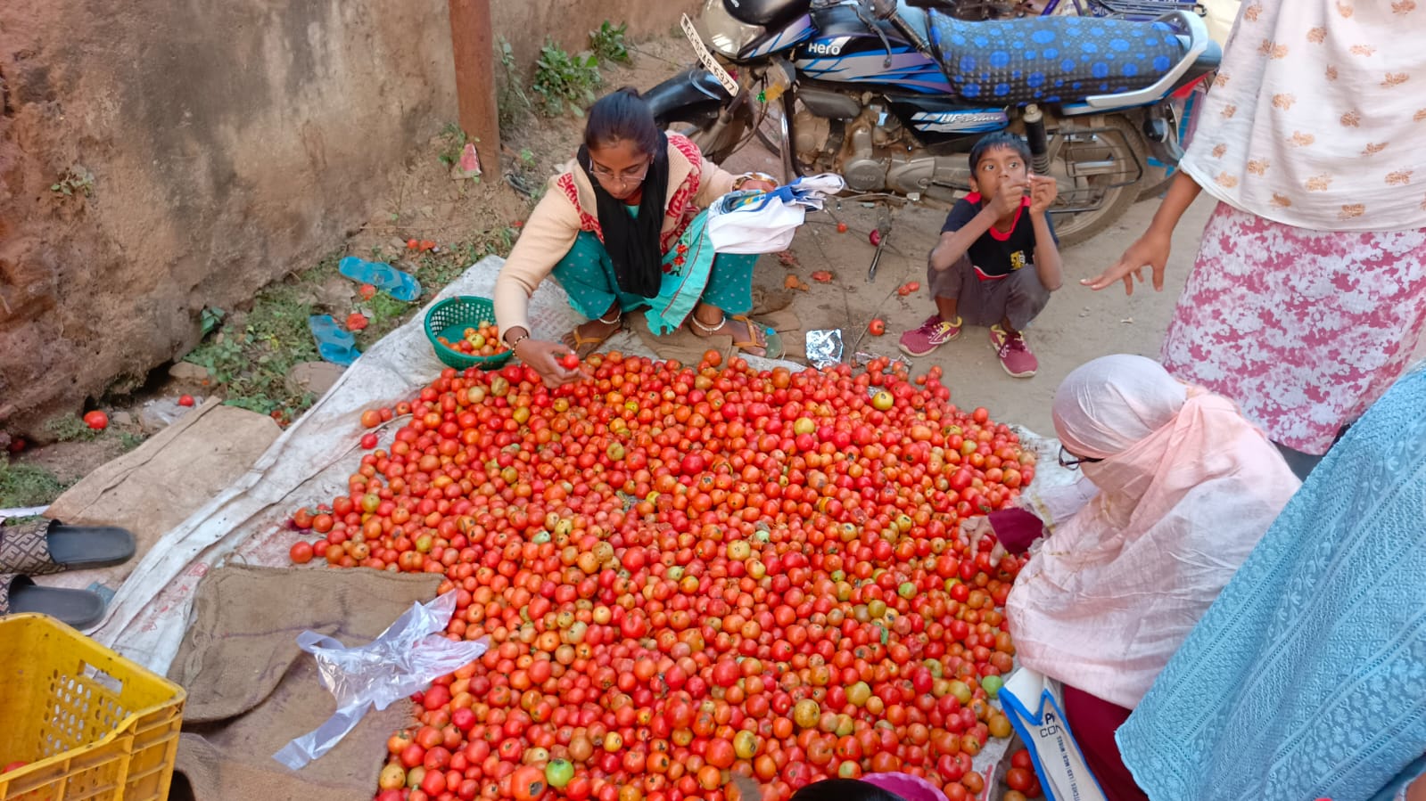इतवारी बाजार में टमाटर खरीदती हुई महिलाएं।