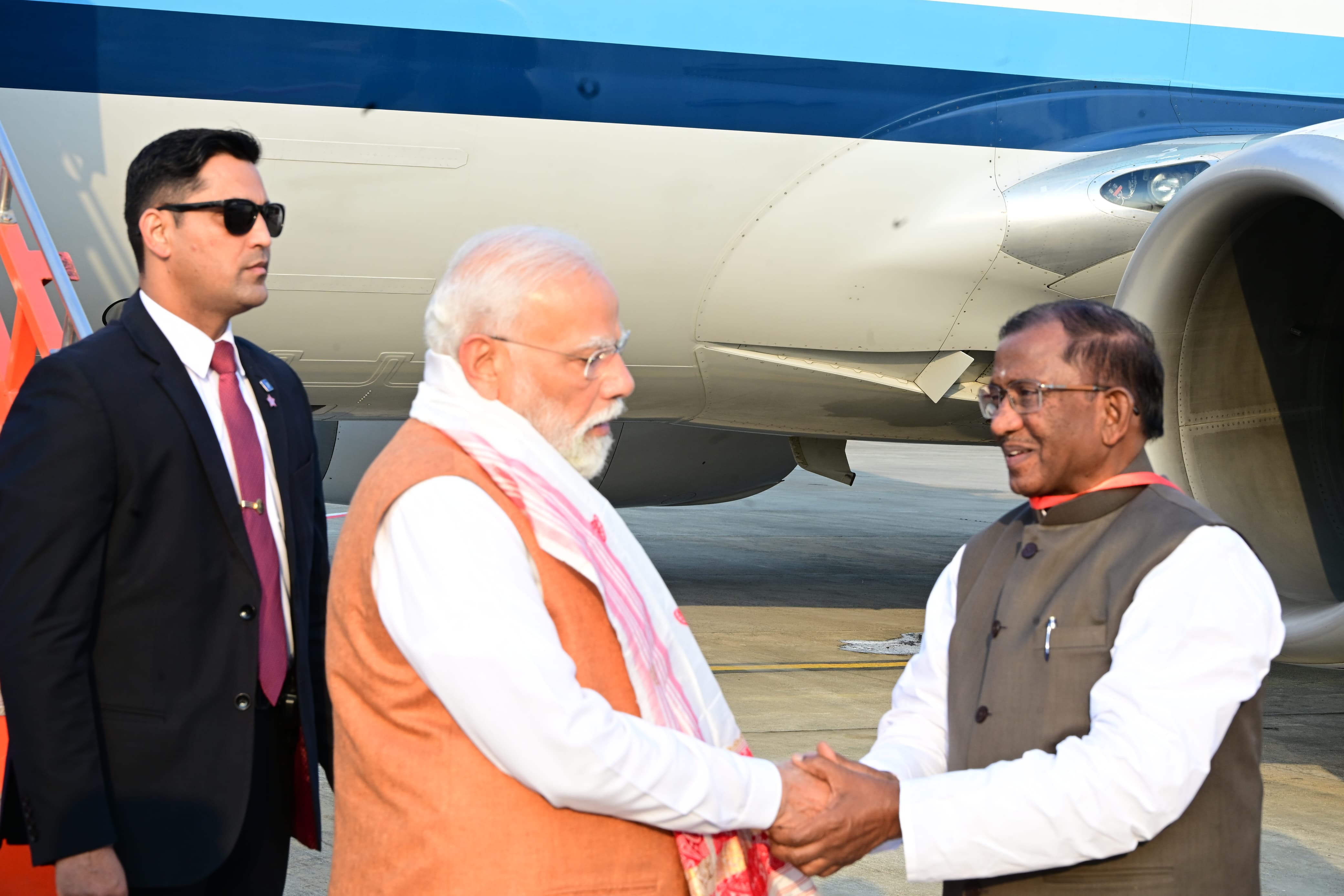 Governor Laxman Prasad Acharya Receiving PM Narendra Modi at Guwahati Airport. Governor Laxman Prasad Acharya Receiving PM Narendra Modi at Guwahati Airport.