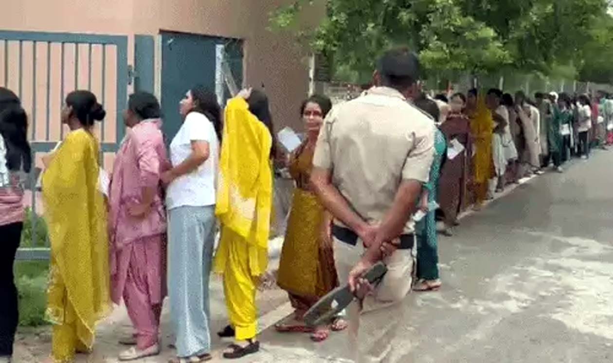 परीक्षा केन्द्र में जाने के लिए लगी लाइन।