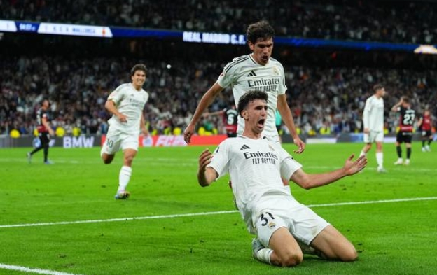 Real Madrid players celebrating after scoring a goal. Real Madrid players celebrating after scoring a goal.