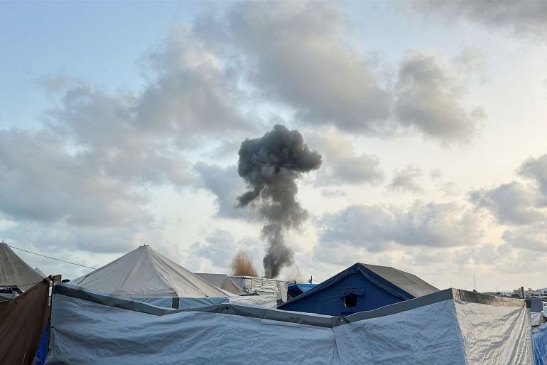 Smoke ascends post-Israeli strikes, viewed from a tent camp for displaced Palestinians in Khan Younis. Smoke ascends post-Israeli strikes, viewed from a tent camp for displaced Palestinians in Khan Younis.