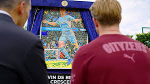 Manchester City Chairman Khaldoon Al Mubarak has today, Tuesday, May 20, 2025, unveiled a mosaic and dedicated a road at the City Football Academy to legendary departing midfield ace Kevin De Bruyne. Manchester City Chairman Khaldoon Al Mubarak has today, Tuesday, May 20, 2025, unveiled a mosaic and dedicated a road at the City Football Academy to legendary departing midfield ace Kevin De Bruyne.