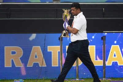 An official removes the winners' trophy from the presentation area after India won the Asia Cup cricket final against Pakistan at Dubai International Stadium.